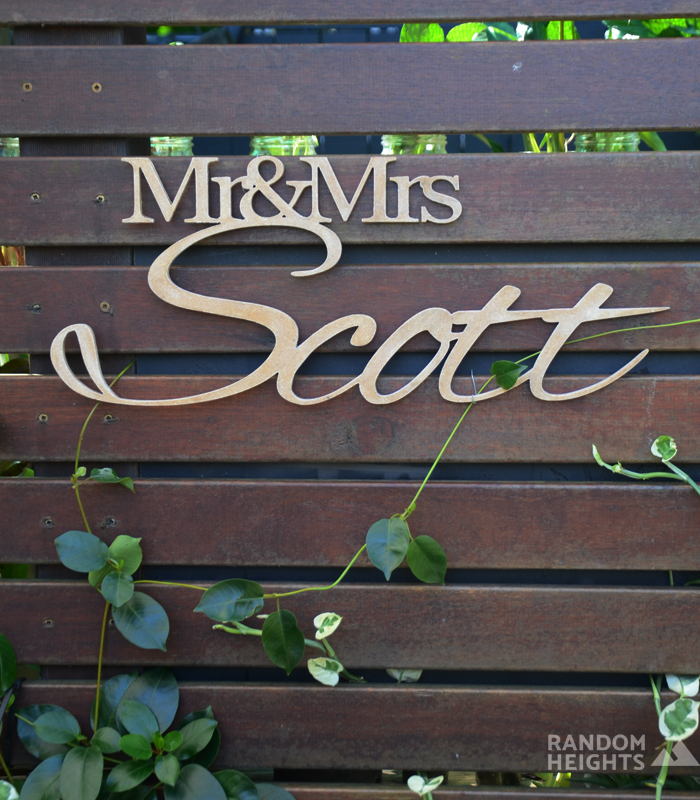 Wedding Sign Mr&Mrs Scott displayed on slats of wood in the garden